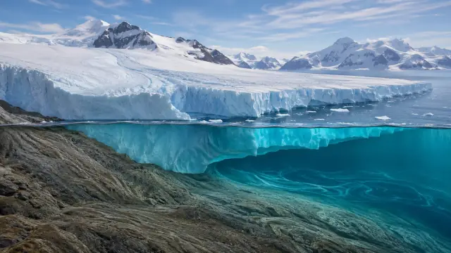 Reconstruction of an Antarctic ice shelf at its grounding line, the cliff above water and the submerged ice glowing turquoise below the surface.
