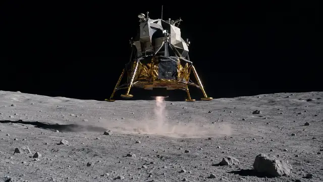 Reconstruction of the Apollo 11 lunar module descending on its engine plume toward the gray lunar surface, blown dust spreading below it against a black sky.