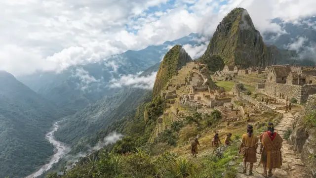 Reconstruction of Machu Picchu on its ridge with Huayna Picchu rising behind, agricultural terraces stepping down toward the Urubamba gorge.